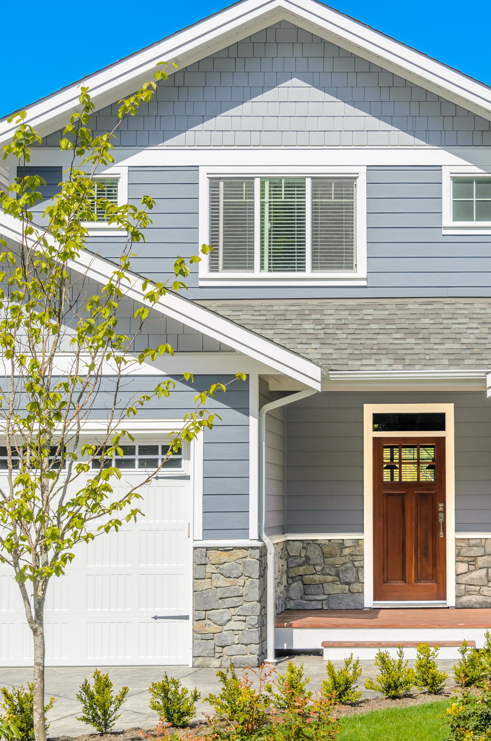 suburban-home-exterior-with-green-yard-and-tree-2026-03-26-10-44-34-utc